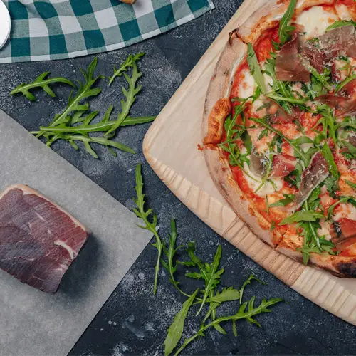 Making Prosciutto Arugula Pizza